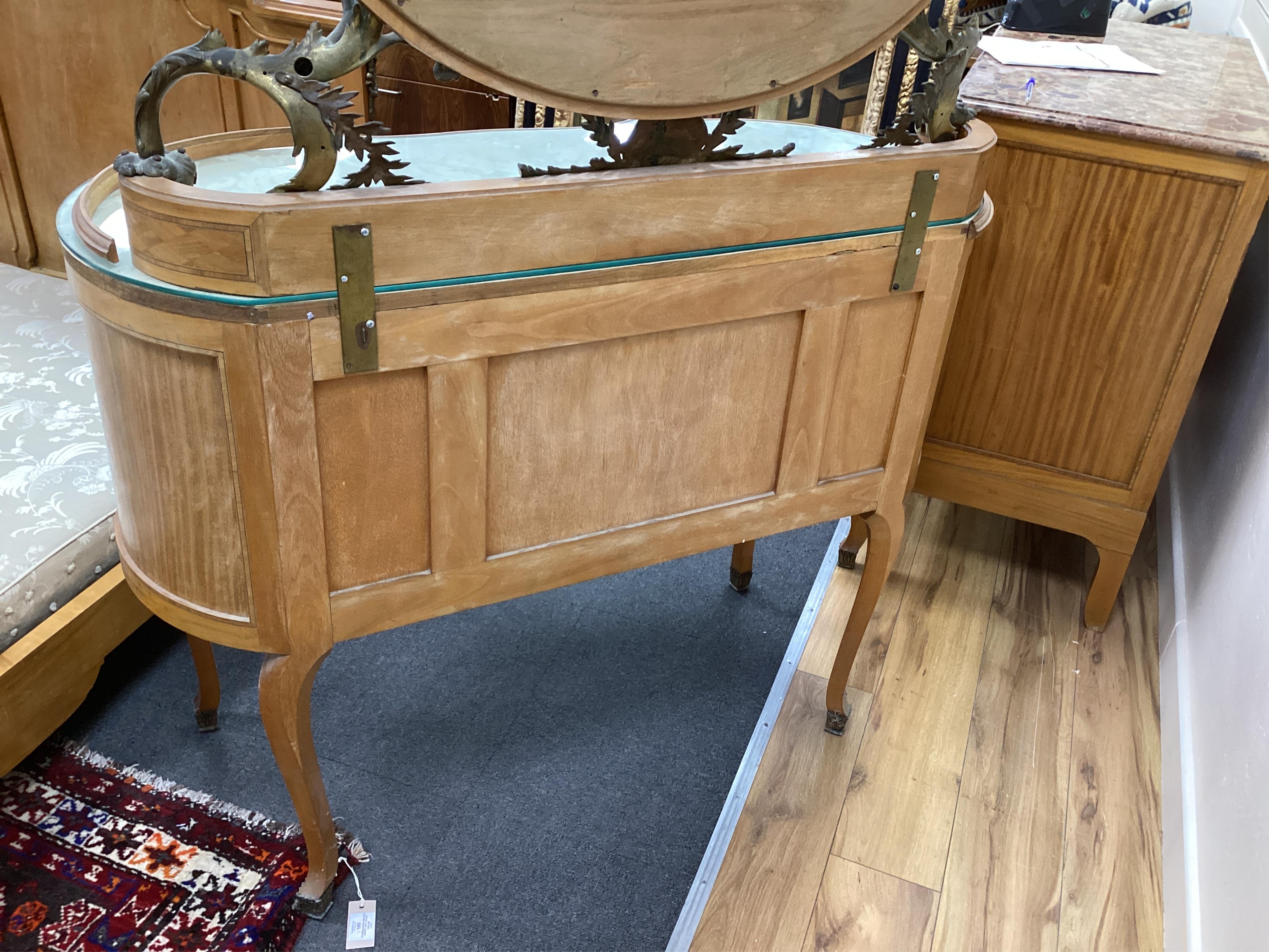 An early 20th century French transitional style gilt metal mounted tulip banded and parquetry inlaid kneehole dressing table, width 115cm, depth 50cm, height 160cm